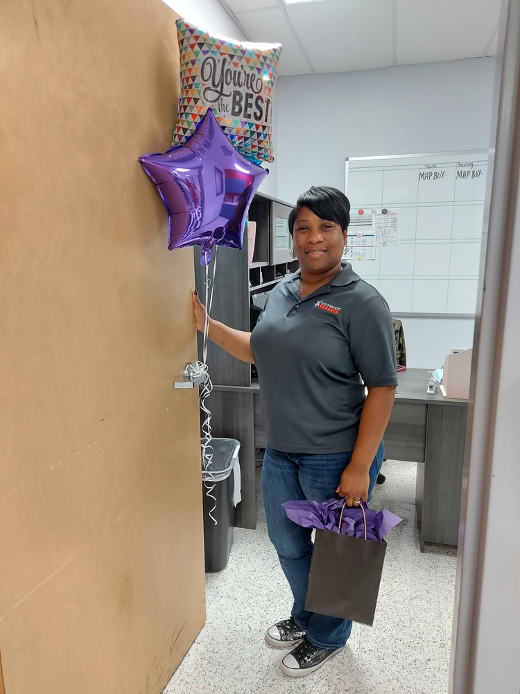 Woman standing holding bag and balloons