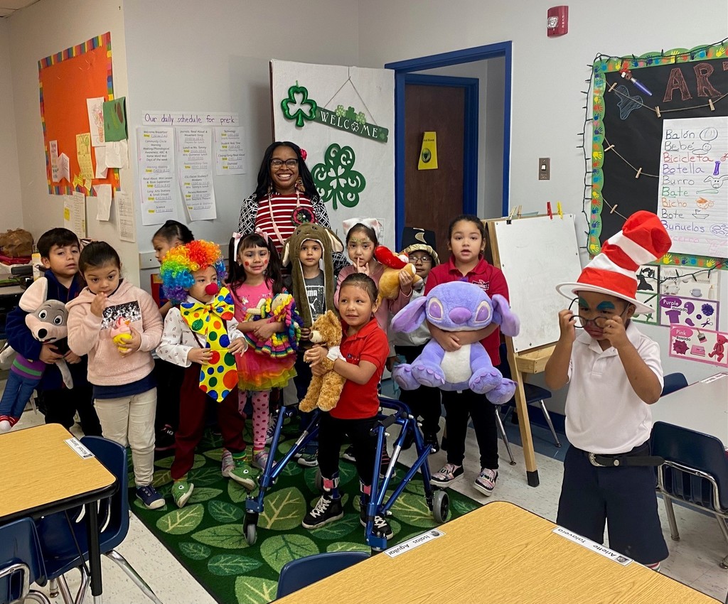 Children and Ms. Johnson coming together for the Dr. Seuss Dress-up Days